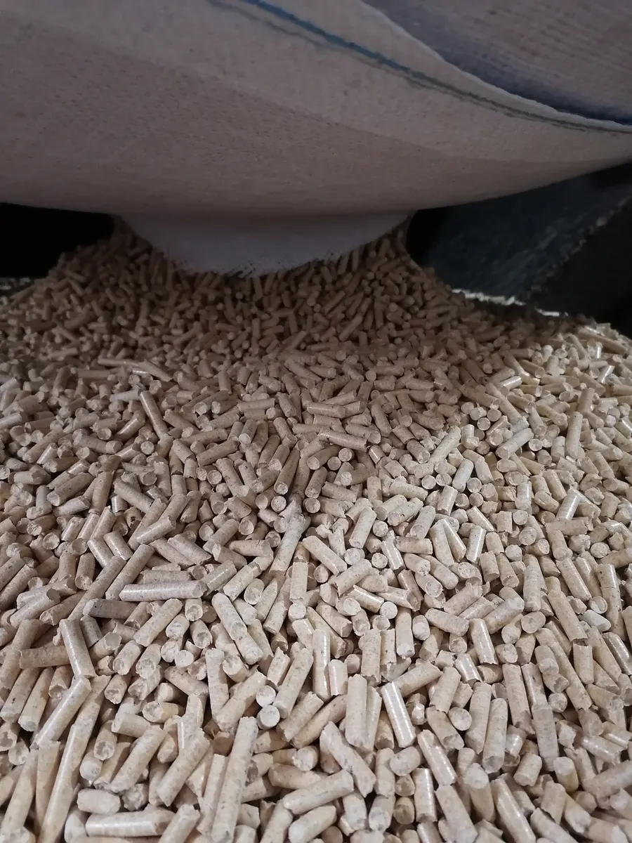 ENplus A1 6-mm-Kiefernholzpellets, die aus einem Kraftpapiersack fließen — Premium Kraft Pellets